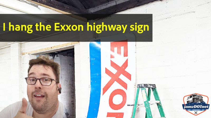 Hanging an Exxon highway sign at the building, with no help
